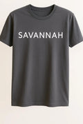 Gray unisex graphic T shirt featuring the word Savannah in bold white typography on the front with a clean minimalist design.