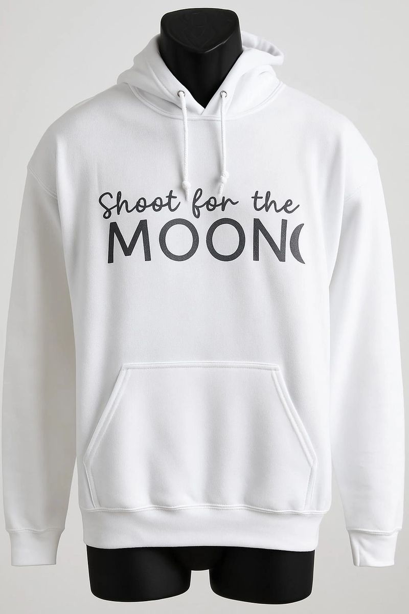White unisex hoodie featuring a minimalist Shoot for the Moon typography design for everyday casual wear, streetwear, and modern fashion.
