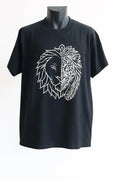 Black unisex graphic t shirt featuring a split lion face design in white line art with one side realistic and the other side ornamental tribal artwork symbolizing strength confidence and courage.