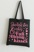 Black cotton tote bag with pink Starlight and Full Moon Kisses graphic design, reusable celestial shoulder bag for shopping, travel, school, astrology lovers, and moon aesthetic fashion.