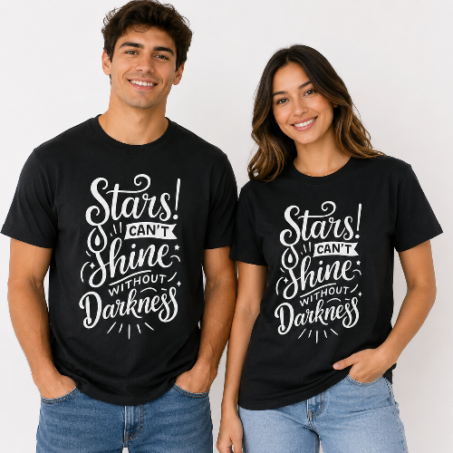A man and a woman modeling matching black graphic t-shirts with the white text 'Stars! CAN'T Shine WITHOUT Darkness' on the front, set against a plain light background.