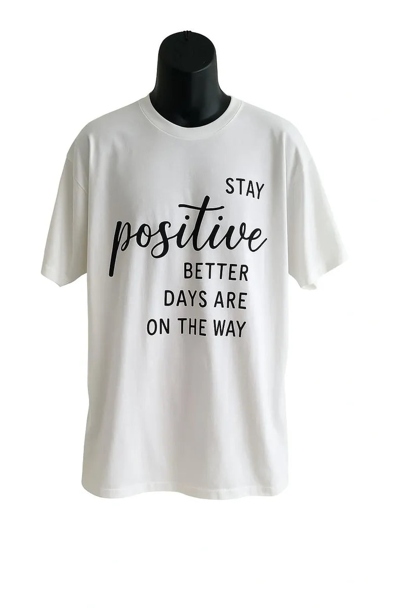 White graphic t-shirt featuring a motivational "Stay Positive" quote design in stylish typography, inspirational unisex graphic tee for everyday wear.