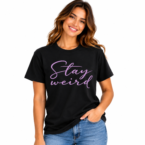 Woman wearing a black Stay Weird graphic T-shirt with purple script lettering
