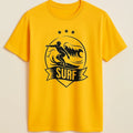 Yellow surf graphic short sleeve t shirt featuring a bold wave and surfboard design for beach lovers, surfers, vacation wear, and casual summer fashion