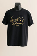 Black t-shirt with 'Sweet Dreams' text on a mannequin against a beige background