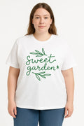 Person wearing a white t-shirt with 'sweet garden' text and green leaves on a white background