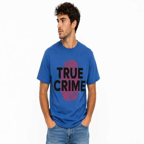 A man wearing a blue crewneck t-shirt with a graphic print that reads 'TRUE CRIME' in black text over a red fingerprint design, paired with blue jeans, against a plain white background.