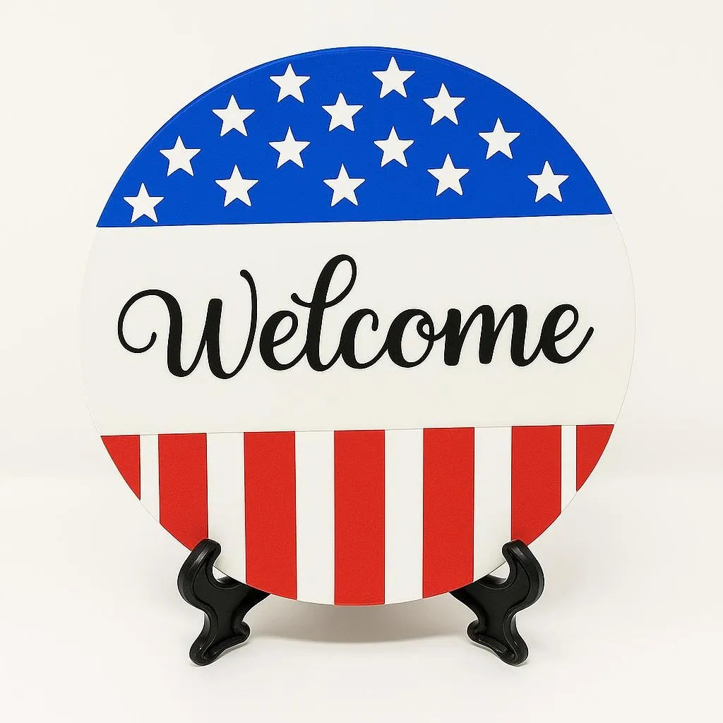 Round welcome patriotic coaster with American flag inspired red white and blue design, decorative welcome table coaster for patriotic home décor, farmhouse coffee table accessory, USA themed summer decoration, patriotic entryway décor, Fourth of July tabletop accent, Americana style drink coaster, festive home decoration for Memorial Day and Independence Day gatherings, patriotic hostess gift and seasonal home décor accessory.