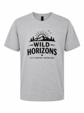 Heather gray unisex short sleeve t-shirt featuring a black Wild Horizons mountain adventure graphic with evergreen trees, sunrise, and outdoor typography on the front.