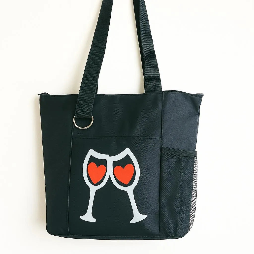 Black reusable tote bag with two wine glasses and heart graphic design, shoulder tote for shopping, travel, everyday carry, wine lovers, romantic gifts, casual outings, and stylish lifestyle accessories