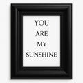 Minimalist You Are My Sunshine framed wall art featuring elegant black typography in a modern black frame for nursery, bedroom, living room, and home décor.